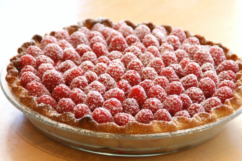 Fresh Raspberry Pie on a wooden tabletop