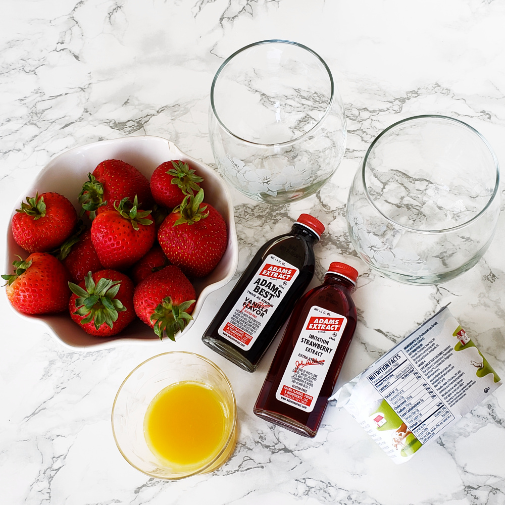 Ingredients for Strawberry Lassi on a marble counter on ShockinglyDelicious.com