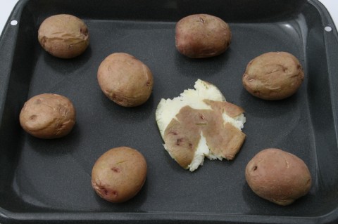 Red potatoes on a grey baking pan