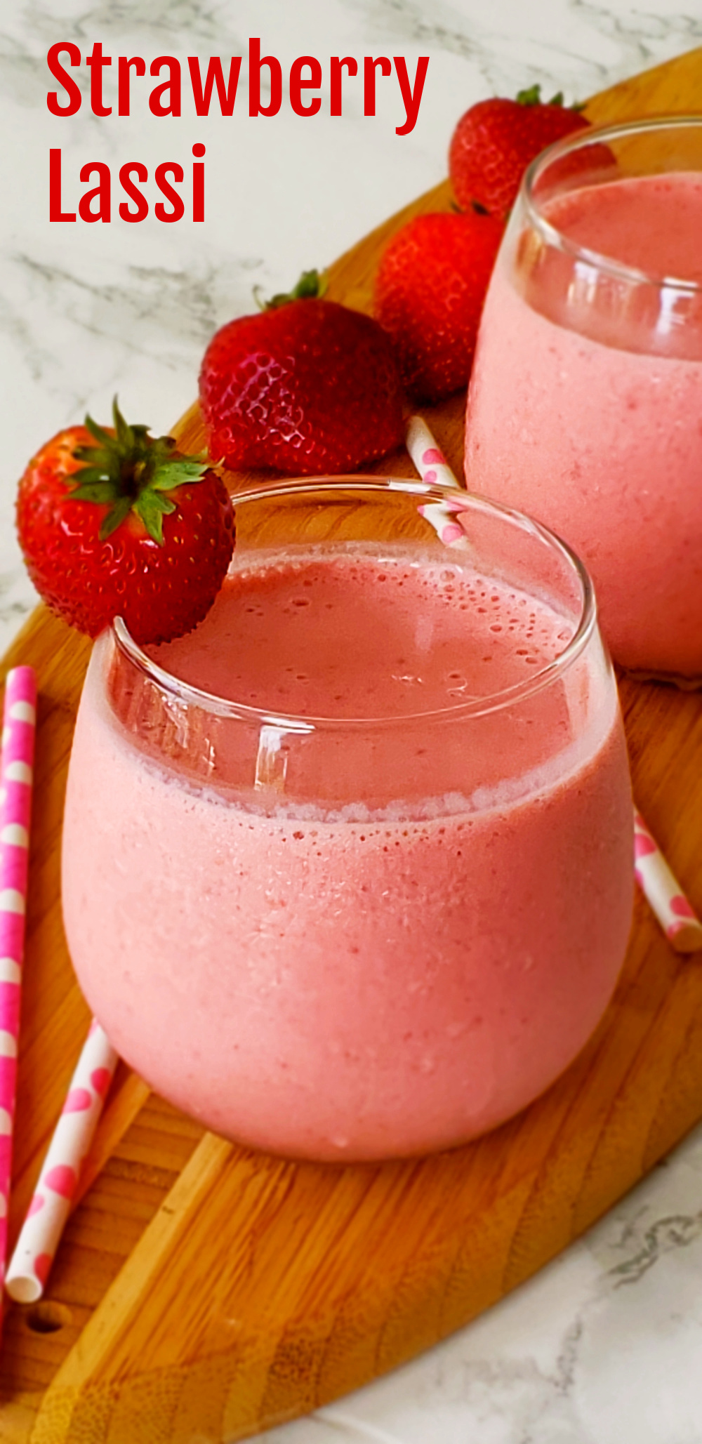 Strawberry Lassi yogurt drink on a wooden board on ShockinglyDelicious.com