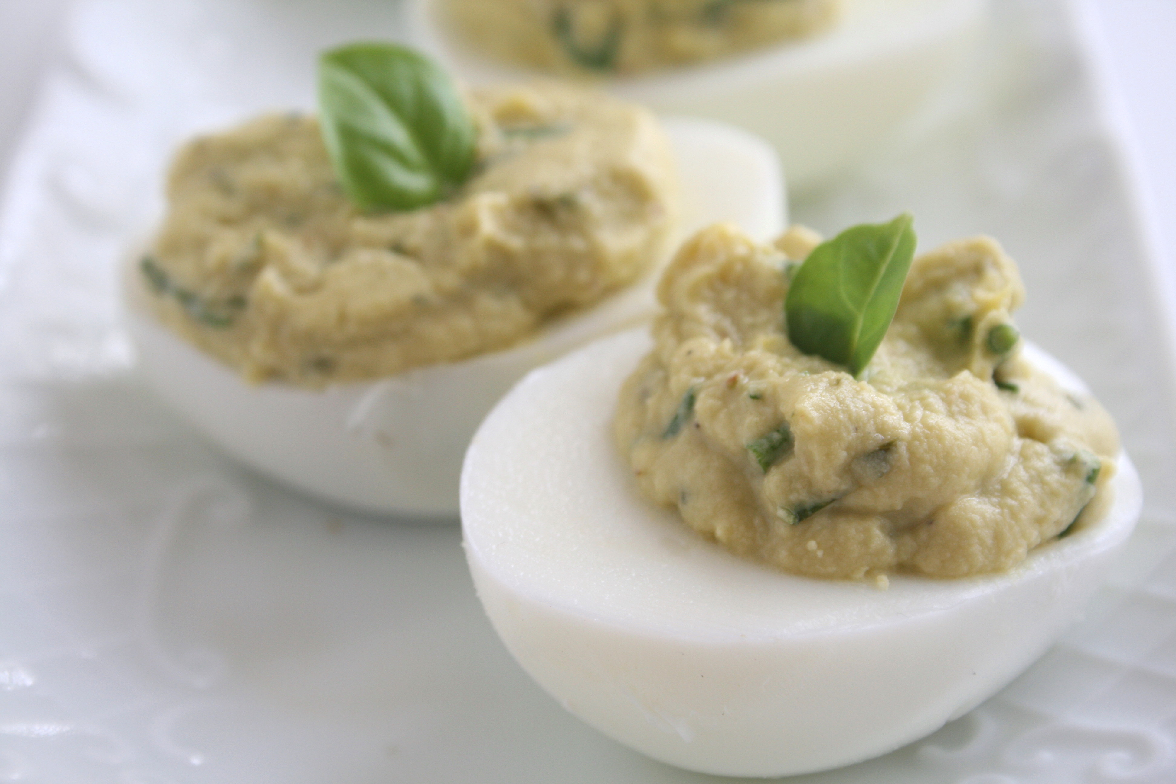 Sweet Basil Deviled Eggs on a white serving plate