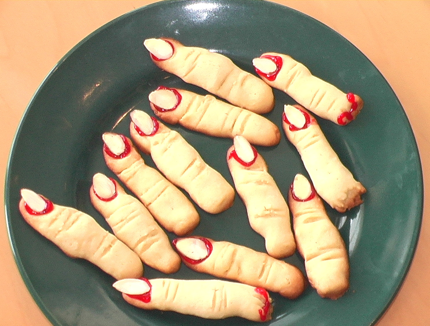 Witches Digits cookies resembling fingers on a green plate for Halloween | ShockinglyDelicious.com