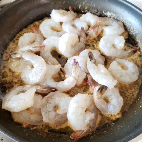 Raw shrimp go into the skillet sauce for Weeknight Skillet Shrimp on ShockinglyDelicious.com