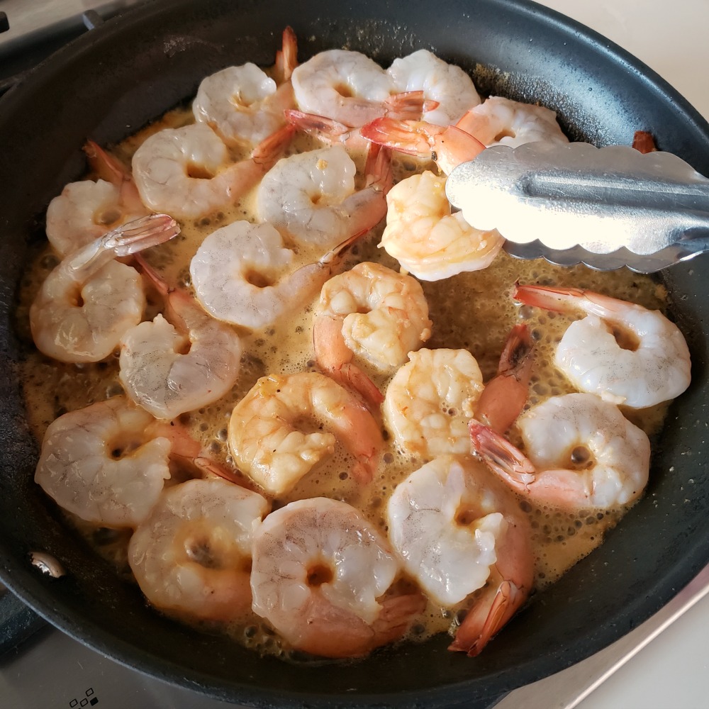 …and then turn the shrimp using a tongs so the other side cooks, as well.