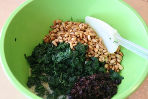 Mixing up Spinach Pie with Pine Nuts and Currants