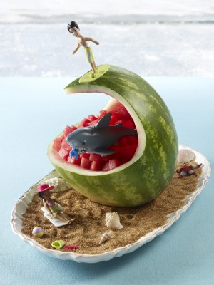 Surfer on wave carved watermelon