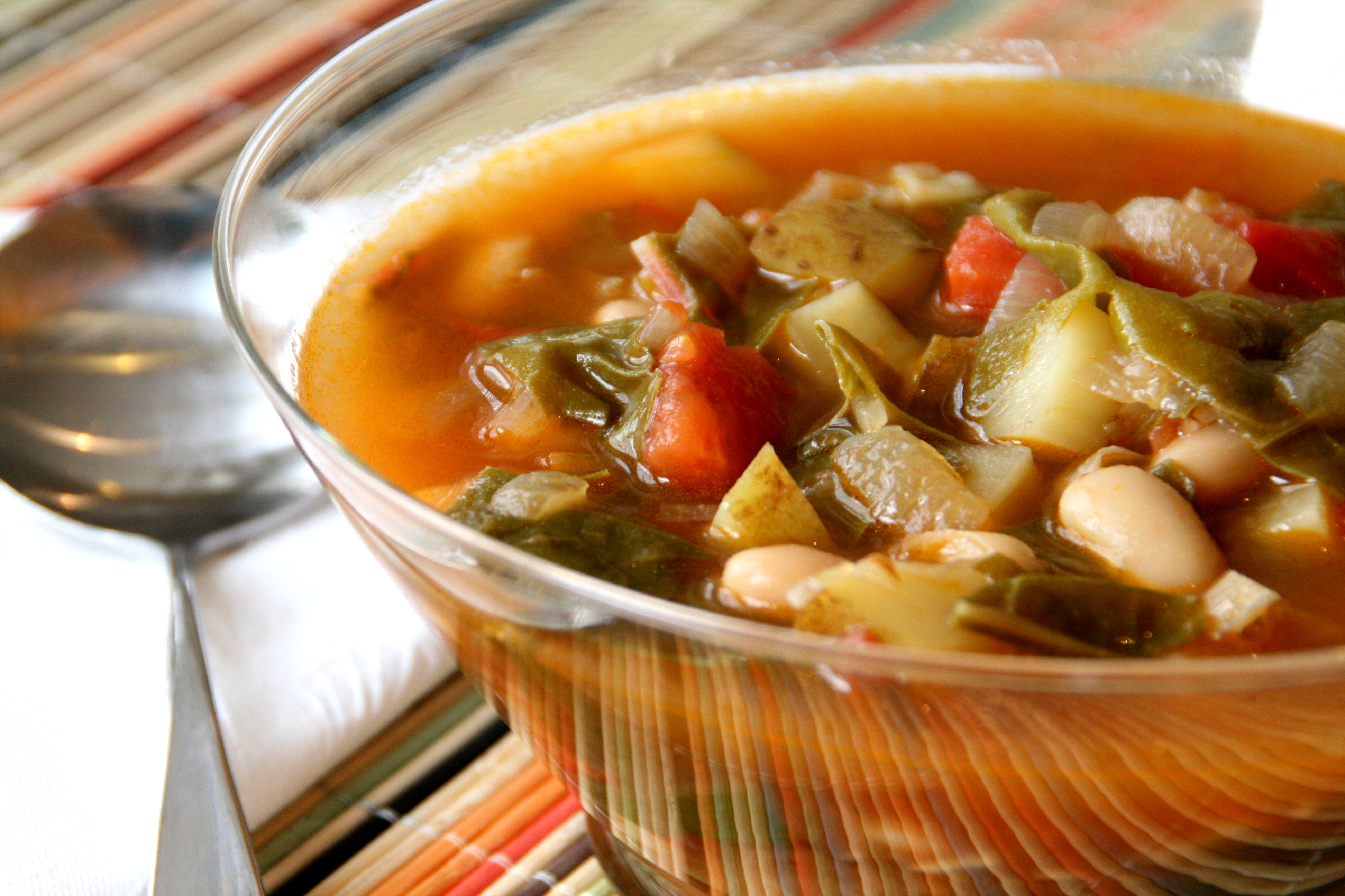 Glass bowl of chunky Vegetarian Chard Soup on Shockingly Delcious