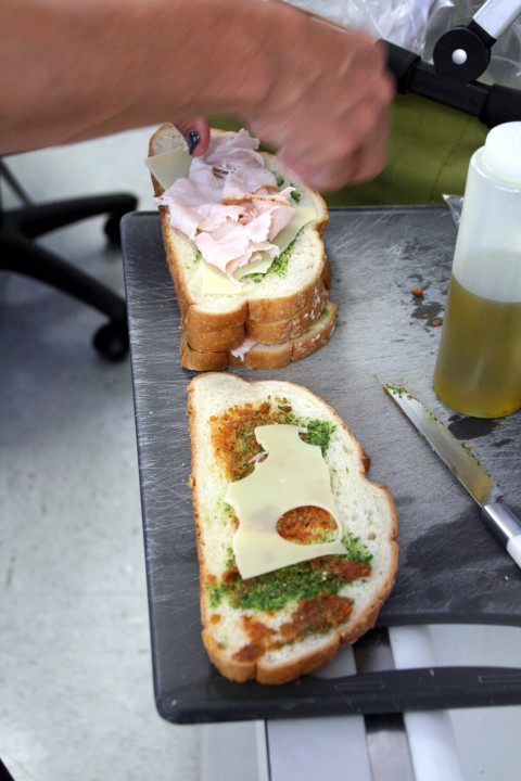 Turkey Pesto Panini making sandwiches