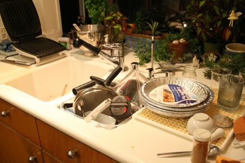 Messy kitchen dishes piled up