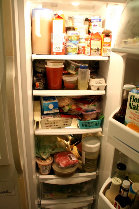 Messy kitchen full refrigerator