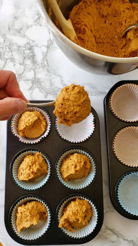 Portion Cheater Pumpkin Muffins into muffin tins on ShockinglyDelicious.com