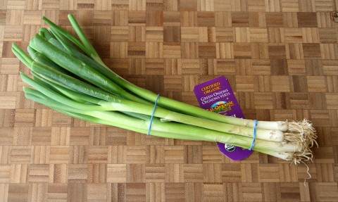 Green onions on a wooden cutting board