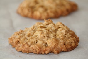 Closeup of 2 Flourless Caramel Oat Cookies on white parchment paper