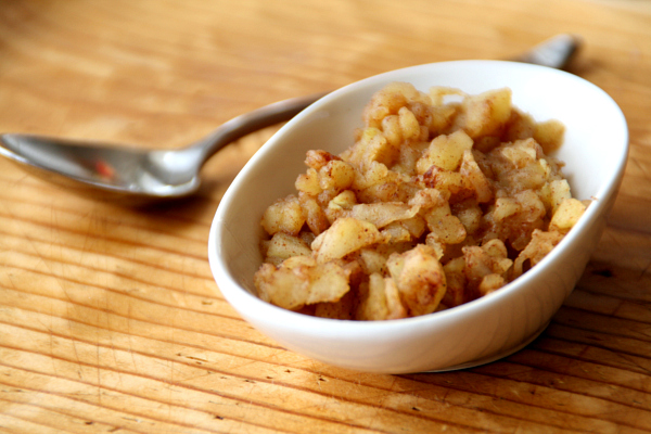 Chunky Applesauce for One in a white oblong bowl with a silver spoon alongside