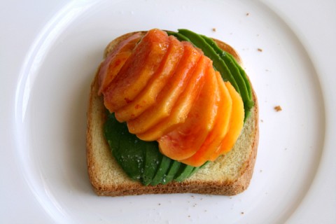 Peach and avocado slices on toast