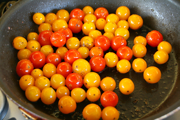 Cherry tomatoes sizzling in a skillet on ShockinglyDelicious.com