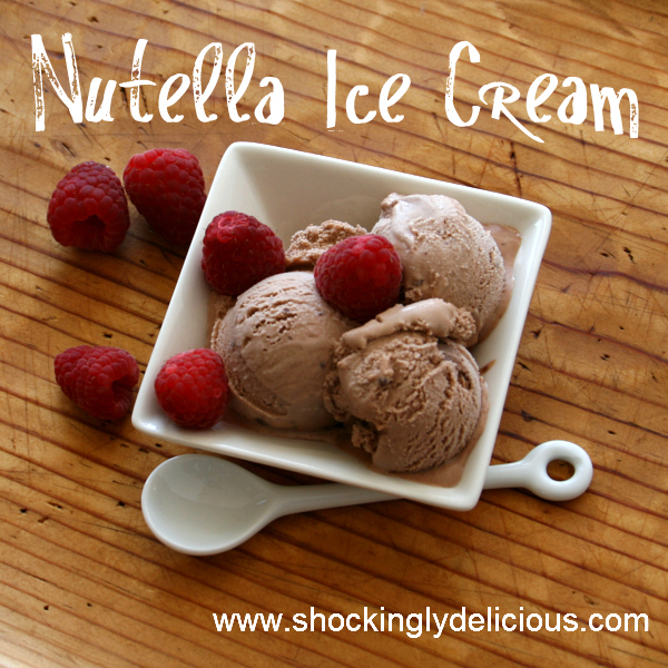 3 scoops of Nutella Ice Cream with raspberries on top in a square white bowl on a wooden counter top