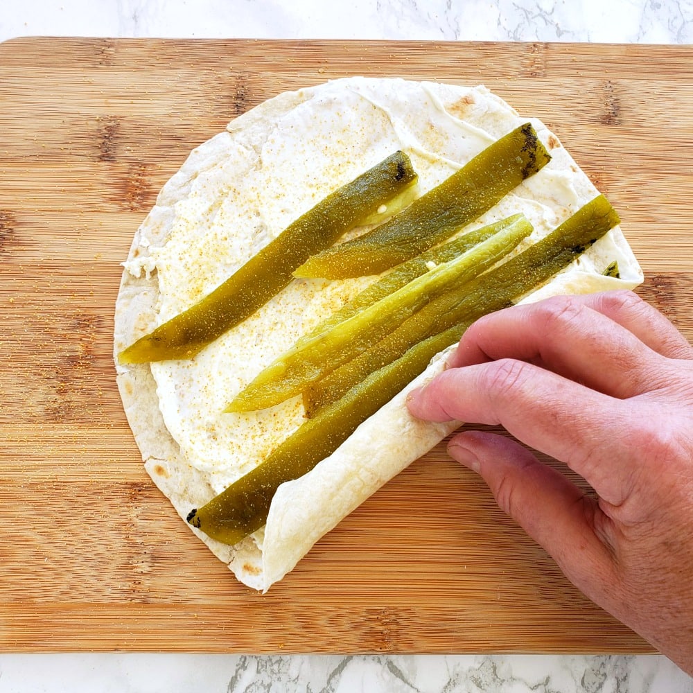 Rolling up Poor Man's Burrito Hatch Chile Roll-Up on ShockinglyDelicious.com