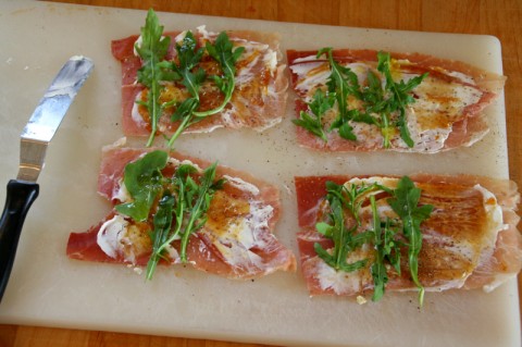 Assembling the Prosciutto Goat Cheese Rolls with Fig Preserves and Arugula on Shockingly Delicious. Recipe here: https://www.shockinglydelicious.com/?p=10622