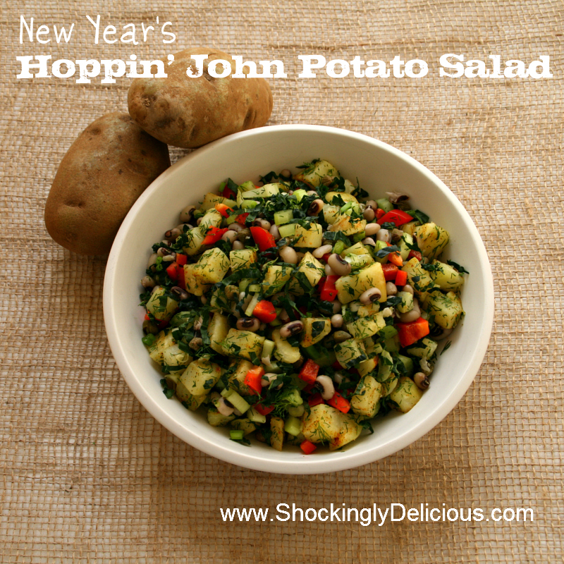 New Year's Hoppin' John Potato Salad in a white bowl against a burlap background