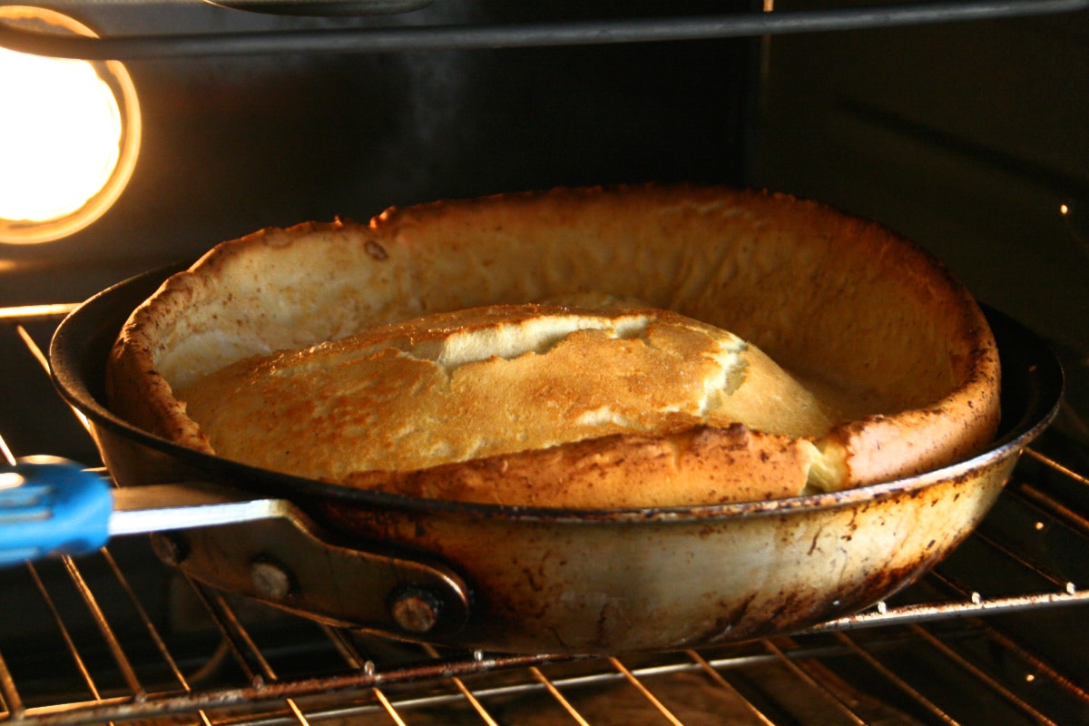 Dutch Baby Pancake in a skillet on an oven rack 