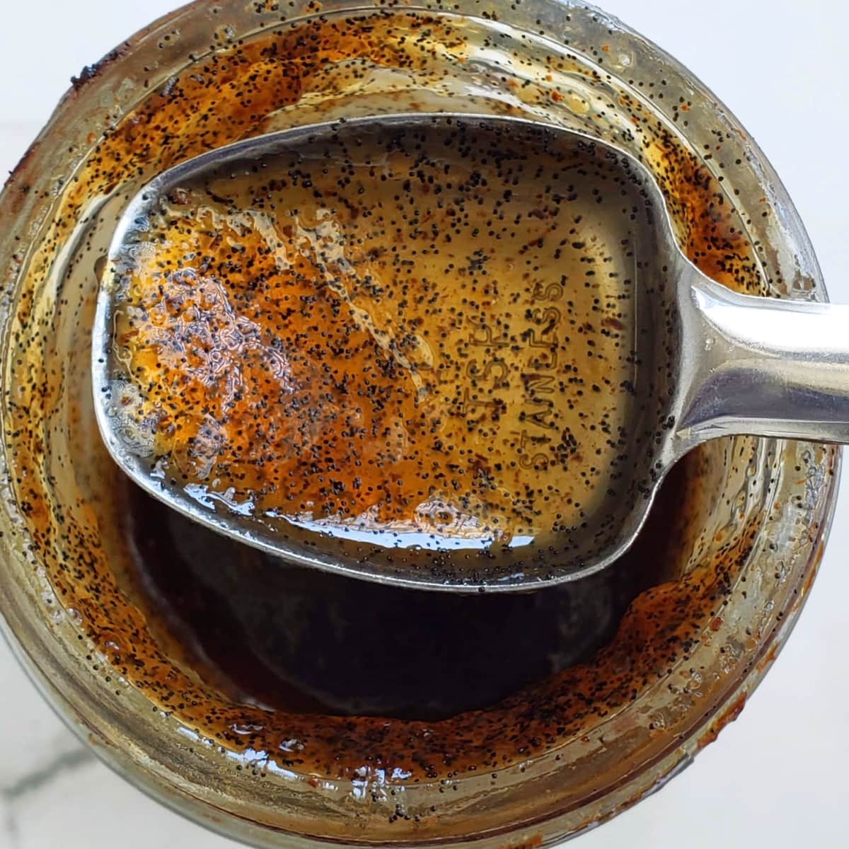 Heilala Vanilla Paste on a teaspoon resting on the jar