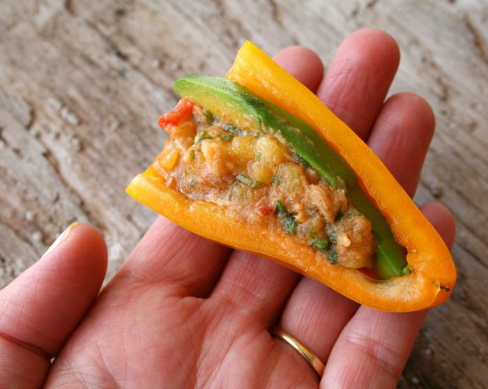 Tuna Pepper Poppers with Avocado and Pineapple on an outstretched hand on Shockingly Delicious