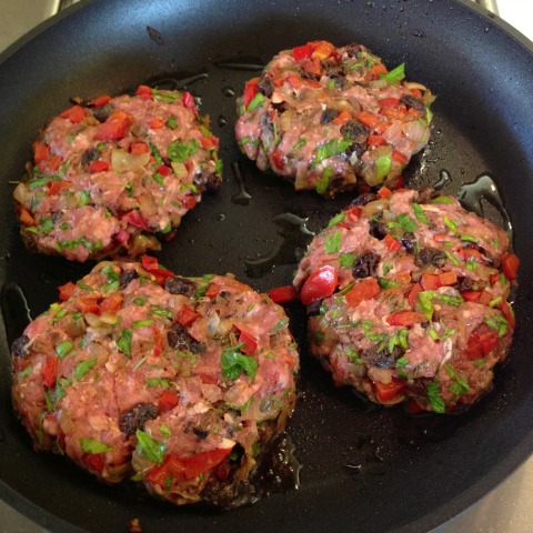 4 Lamb Patties in a black skillet blog Shockingly Delicious