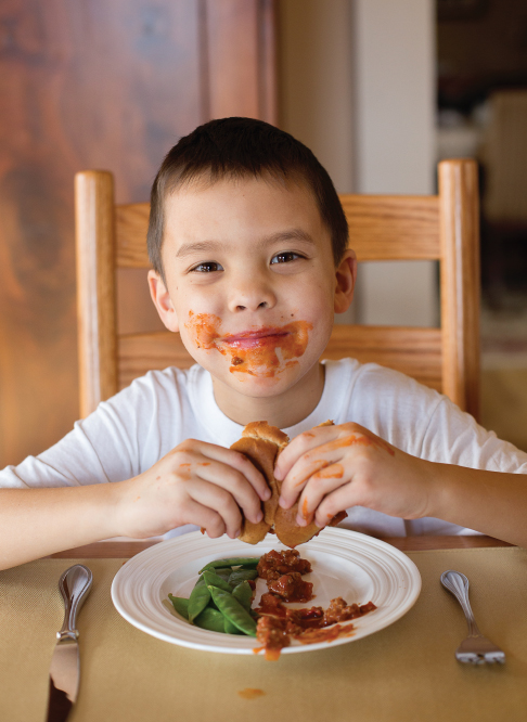 Joel from the TV show eating his Very Sloppy Joels sandwich on Shockingly Delicious