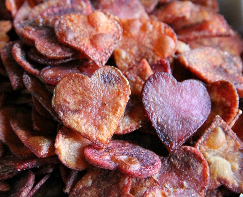 Potato slices cut into heart shaped, dyed with beet juice and baked for Heart-Shaped Potato Chips | www.ShockinglyDelicious.com