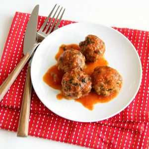 4 turkey meatballs on a white plate on a red napkin