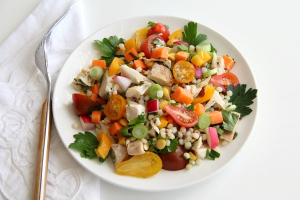 Chicken and Israeli Couscous Vegetable Salad in a white bowl on a white counter