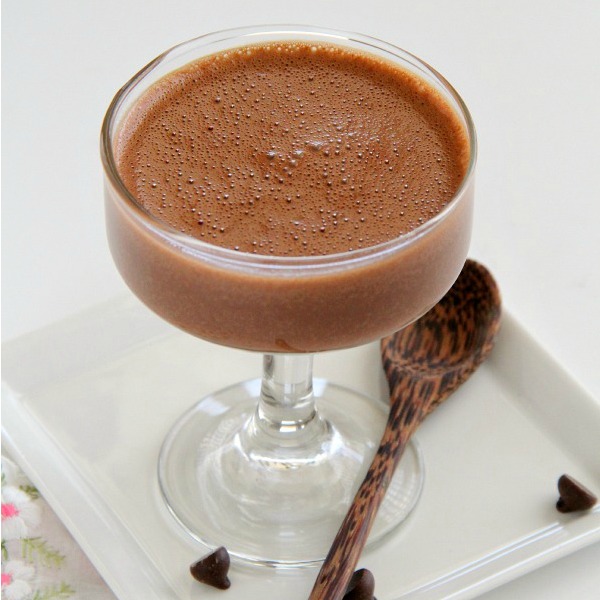 Creamy Chocolate Blender Mousse in a glass goblet with a wooden spoon alongside