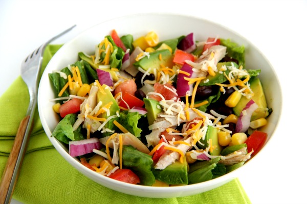 Chopped Mexican Chicken Salad in a white bowl with a green napkin