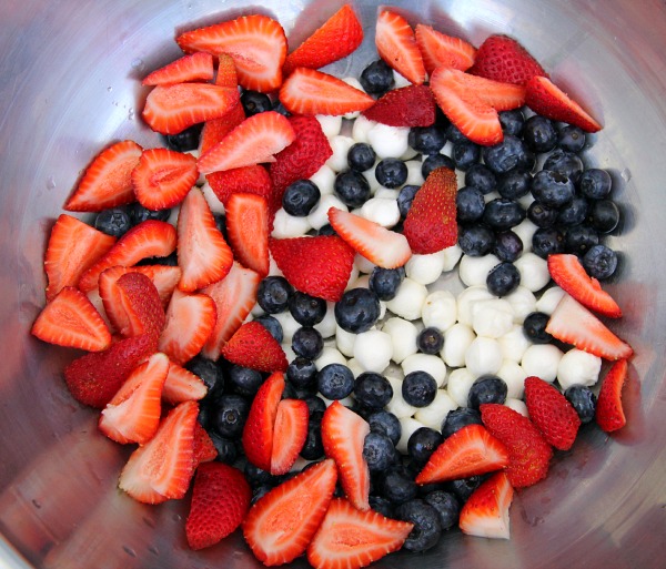 Red, White and Blue Fruit and Cheese Salad in a stainless steel mixing bowl | ShockinglyDelicious.com
