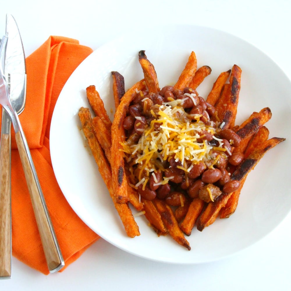 Sweet Potato Fries on a white plate with with Chili and Cheese on top on ShockinglyDelicious.com