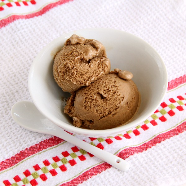 2 scoops of Vegan Root Beer Coconut Ice Cream in a white bowl with an Italian tea towel underneath