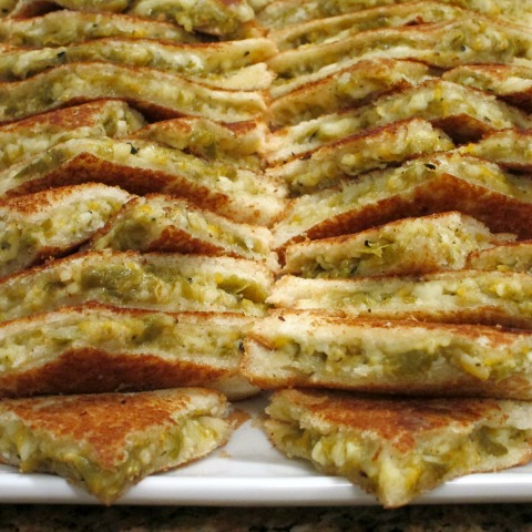 Hatch Grilled Cheese Sandwiches cut in quarters and stacked on a white platter | Hatch Chile recipe | ShockinglyDelicious.com