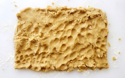 Brown Sugar Shortbread being patted on the board on ShockinglyDelicious.com