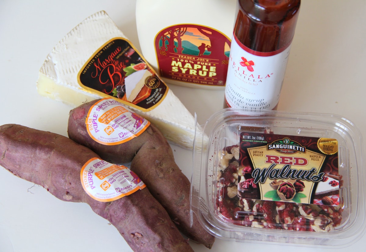 Ingredients for Purple Sweet Potato Skins with Brie and Sweet Walnuts on a white counter