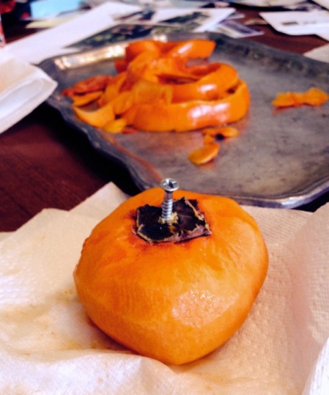 Put a screw in the persimmon to hang it on Shockingly Delicious