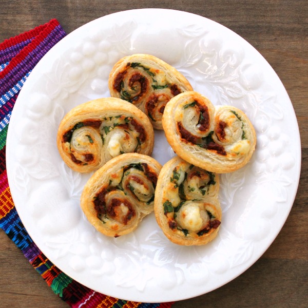 5 Savory Mexican Elephant Ears on a white embossed plate with a colorful napkin to the left side