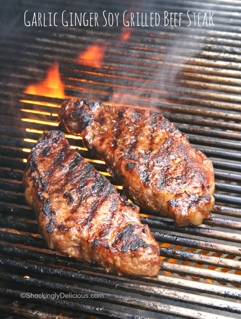 Garlic Ginger Soy Grilled Beef Steak on the flaming grill on ShockinglyDelicious.com