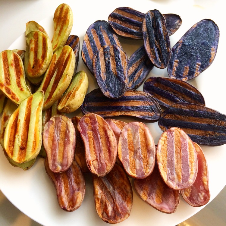 Grilled Tricolored Idaho Potato Fingerlings on a white plate