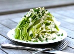 Karen's Kitchen Stories The Wedge Salad on a white plate on a wooden table