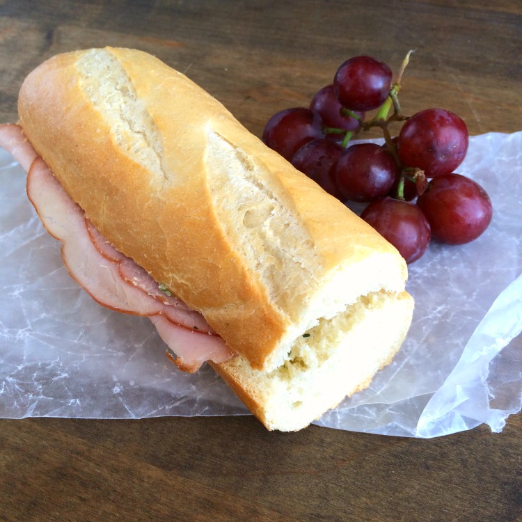 French Ham and Butter Sandwich on a baguette with grapes alongside