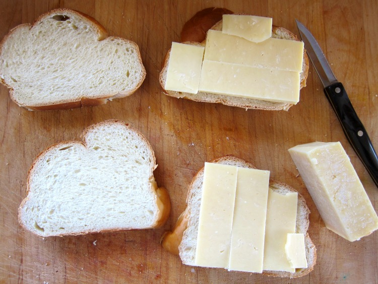 Assembling grilled cheese sandwiches with challah and cheese on ShockinglyDelicious.com