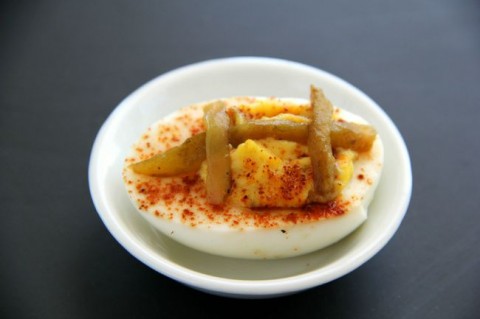 Little football-shaped Hatch Chile Deviled Eggs make great tailgating food. Easy recipe on ShockinglyDelicious.com