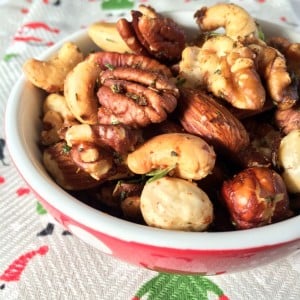Best Bar Nuts in a little red bowl set on a Christmas tea towel