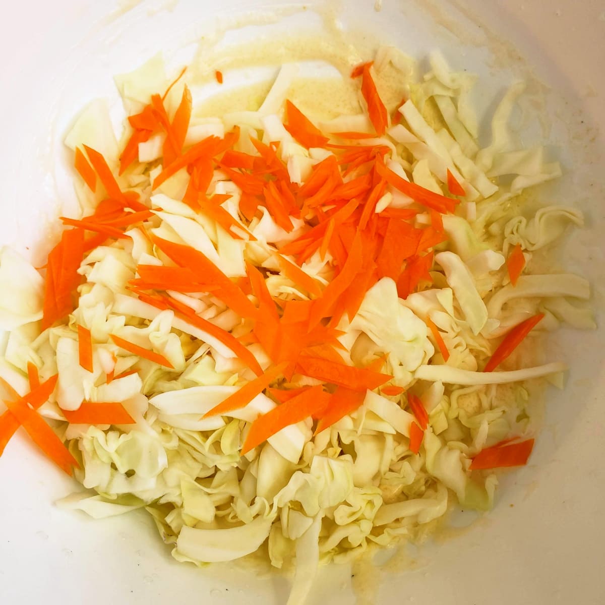 Carrots and cabbage in a mixing bowl on ShockinglyDelicious.com